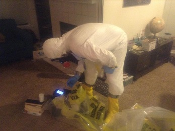 A man in a radiation suit takes measurements inside an apartment