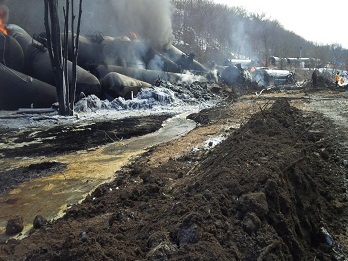 Image ot derailed train cars releasing oil