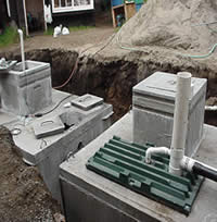 Septic tanks in back yard inside of an earthen trench prior to covering.