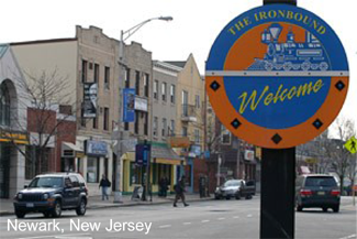 A photograph of a sign that says Welcome The Ironbound with community in the background.