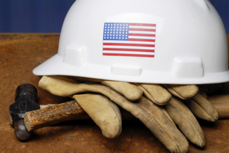 A photograph of a hard hat and work gloves.
