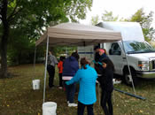 EPA staff assist students with water quality experiments at the Canoemobile Event at Blessing of the Bay Boathouse. Students used USGS test kits to measure temperature, pH and turbidity.