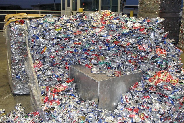 This is a picture of many aluminum cans, all of which are flattened. 