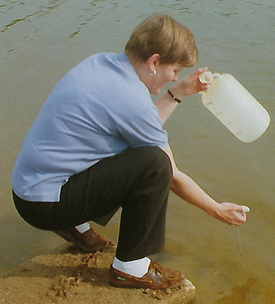 Kris Brenner Collecting Water Sample