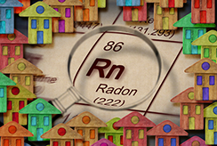 Radon symbol (Rn) surrounded by toy houses