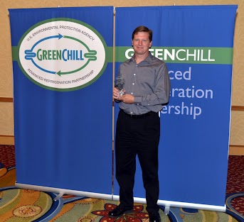 Mike Ellinger from Whole Foods accepts an award from GreenChill for Goal Achievement