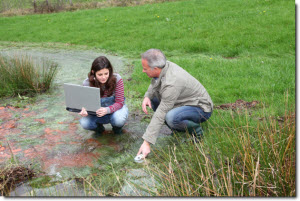 man and woman testing water and tracking data on a laptop