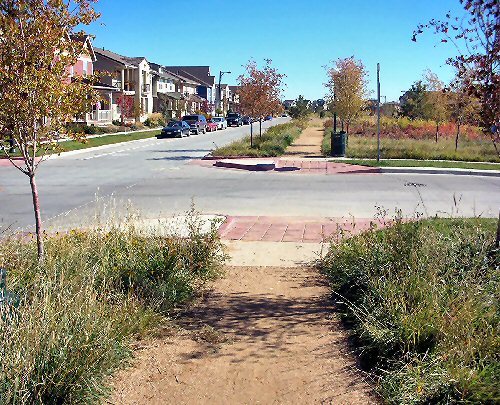 Street corner in Stapleton neighborhood showing soft running pathways.