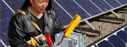 Woman with electric multi-tester working on solar panels
