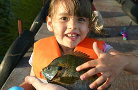 Presenting a fish to a little girl 