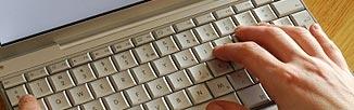 image of white keyboard with hand typing