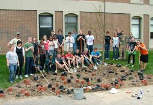 Group Photo on a pile of empty flower pots at project completion