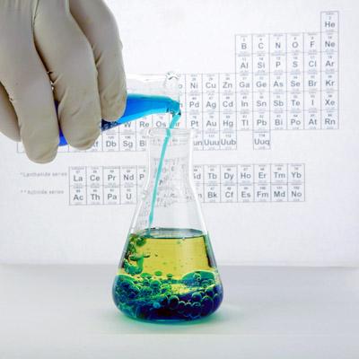 Scientist pouring liquid into Erlenmeyer flask