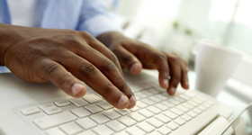 Hands typing on keyboard