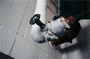 Photo of pipe wrapped with asbestos containing material