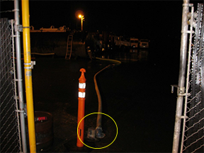 photo of hose from tank inserted into drain