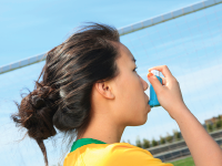 Photo: Girl on a soccer field with an inhaler