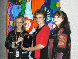 Nola Cooke, Director, Office of Communications and Public Involvement, USEPA Region 8, presents the 2004 Citizens Excellence in Community Involvement Award to Jeri Frye, Co-chair of CCAT and Sara Kitchen, Spokesperson for CCAT.