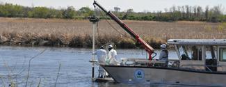 Scientists take sediment samples of the Zephyr site on the Mudpuppy II, EPA's sampling vessel.