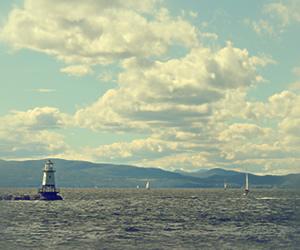 Scenic view of Lake Champlain with a lighthouse in the foreground