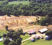 Photo of extensive gully formation from a hog farm built on steep slopes of a forested hillside..