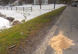 Photo showing the remains of a pile of road salt left after a winter snowstorm.