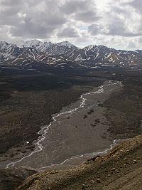 Photo of a mountain range showing streams from precipitation and melting snow caps.
