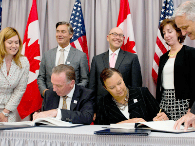 EPA Administrator Lisa Jackson and Canadian Environment Minister Peter Kent sign the updated Great Lakes Water Quality Agreement.