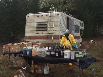 Cleanup worker removes hundreds of chemical containers from an RV.
