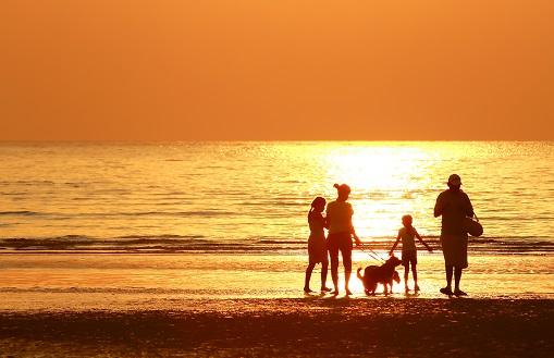 A family plays on the beach