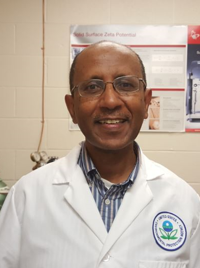 Dr. Sahle-Denessie in his lab coat