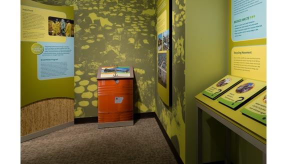 Photo of the EPA exhibit space showing informational panels. Text and photos are not legible in this photo.
