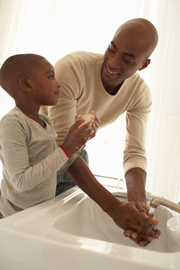 Image of father and son washing hands.