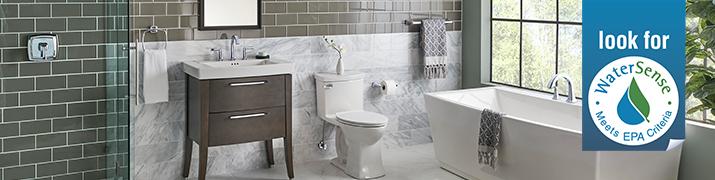 Image of a tiled bathroom with a large window.