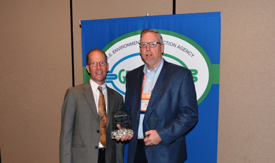 Jon Scanlan accepts Hy-Vee's Superior Goal Achievement and Exceptional Goal Achievement recognitions from Tom Land of the EPA GreenChill Program