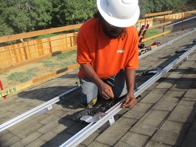 Christopher White working on a solar panel installation