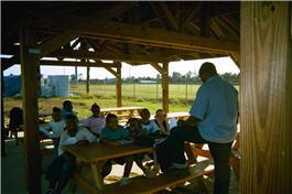 Kids sitting in an outdoor environmental classroom