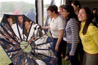 Students examine a solar cooker