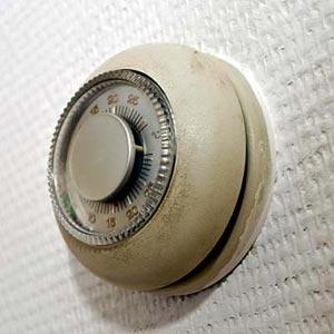 old-fashioned round thermostat, the kind that contains mercury