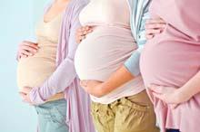 Photo of three women's pregnant bellys