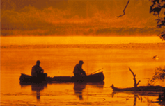 Boaters in canoe on water body