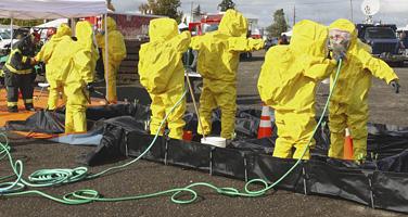 Hazardous waste workers wearing protection suits
