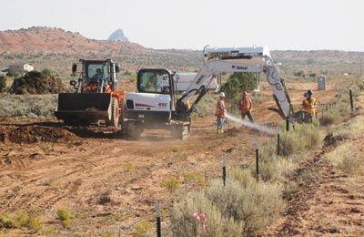 Construction equipment at work in a desert landscape