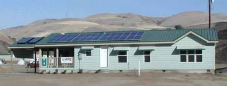 Factory constructed home on site with solar panels and awnings over windows.