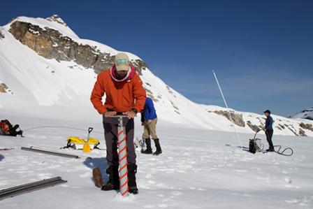 Photograph of scientists making measurements in the snow.