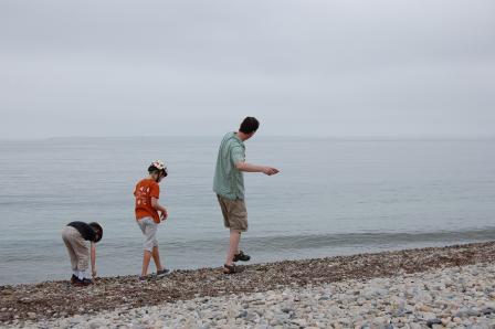 Mike Tryby and his two kids play on a beach