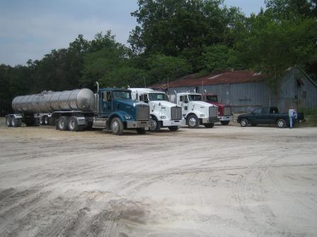 Water transport trucks at the site, and the utilities building