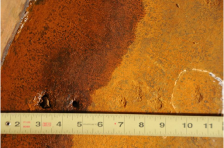 photo showing holes in tank - called matallurgical failures