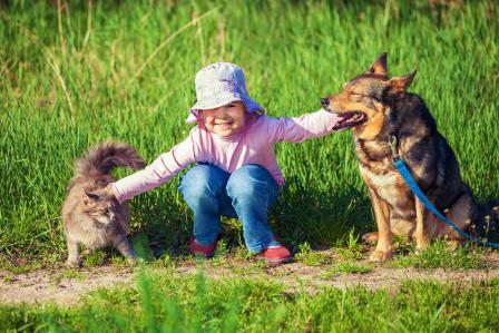 Girl with pet dog and cat