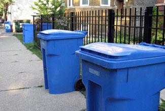 Blue recycle bins curb side.